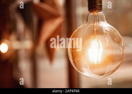 Edison retro glass lamp included light, in background cardboard star, loft style Stock Photo