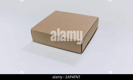 Cardboard box. Side View. With shadows and isolated on white. Stock Photo