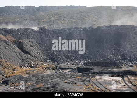 Geological section of soil, layers of coal and rock. Overburden open mine anthracite. Dark texture black color Stock Photo