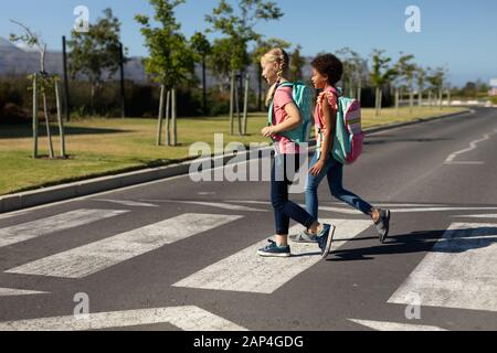 Schoolgirls crossing the road on a pedestrian crossing Stock Photo - Alamy