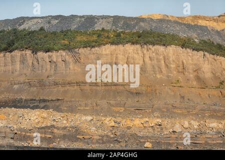 Geological section of soil, layers of coal gold. Overburden open mine anthracite. Consequences after rock explosion Stock Photo