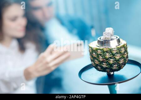 Hot coals hookah in pineapple bowl for smoking shisha traditional Turkish holiday Stock Photo