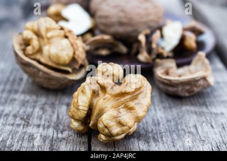 Walnuts kernels on a rustic old wooden table. Fresh walnuts. Harvest walnuts. Stock Photo