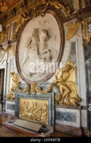 The War Salon at Château de Versailles near Paris and a stucco bas ...