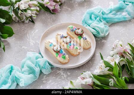 Chocolate icing marshmallows on shortcrust pastry with easter decoration. Dessert on the festive table Stock Photo
