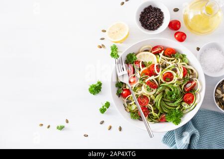 vegan ketogenic spiralized courgette salad with avocado tomato pumpkin seeds Stock Photo