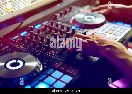 Dj mixes the track in the nightclub at a party Stock Photo