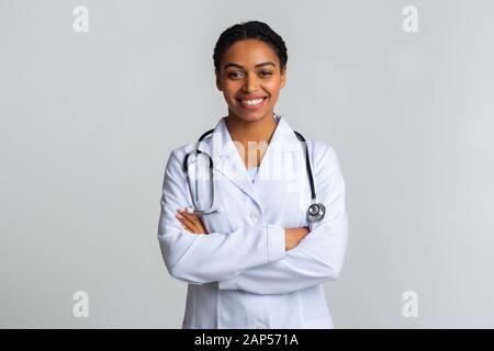 Portraif of black female doctor with stethoscope posing with crossed hands Stock Photo