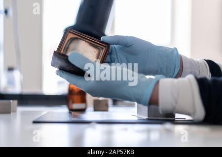 Duesseldorf, Germany. 21st Jan, 2020. The restorer of photography Jessica Morhard examines a photograph. The Düsseldorf City Restoration Centre works on behalf of museums, archives and exhibition houses and was founded in 1976 as a municipal cultural institute. Credit: Fabian Strauch/dpa/Alamy Live News Stock Photo