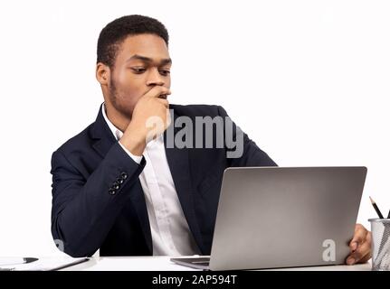 Black guy working on his laptop at office Stock Photo