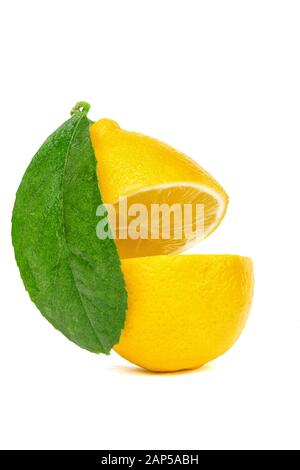 yellow lemon cut into two parts with a leaf isolated on a white background Stock Photo