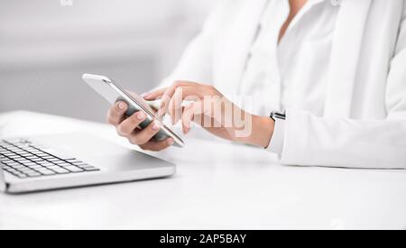 Mexican businesswoman using laptop and cell phone Stock Photo