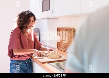 Modern and young couple cooking together at home Stock Photo