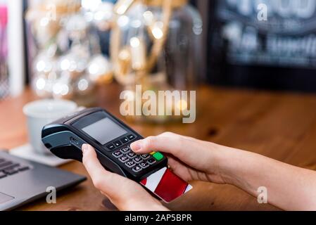 Cropped view of hand entering secure pin code on terminal to pay for the purchase with credit card. Cashless payment Stock Photo