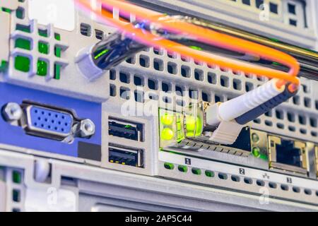 Trunk Internet cable close-up. Optical fiber telecommunication cable is connected to the interface of a powerful server. Fiber optic network Stock Photo