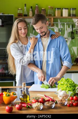 Smiling vegetarian young couple preparing healthy food Stock Photo