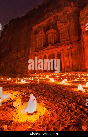 Experience Petra by night by walking the entire Siq to the Treasury to see part of the rock city by candlelight with over 1,500 candles, Petra, Jordan Stock Photo