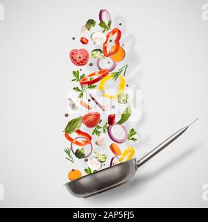 Frying pan with flying vegetables on white Stock Photo