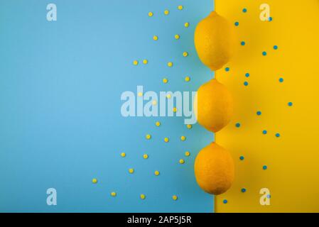 Fresh lemon pattern on a vivid blue background. Flat lay, top view, copy space. Lemon framework, spring, vitamins, body detox concept Stock Photo