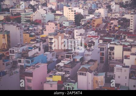 Old apartment buildings at an overpopulated part of Saigon, Vietnam (Ho Chi Minh City). Elevated view. Vintage bleached color effect. Stock Photo