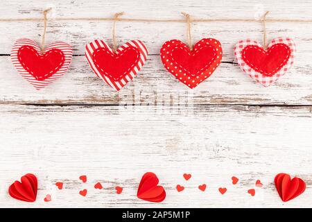 Sewed Pillow Hearts Row Border from Red Fabric and Paper Hearts with Confetti Stock Photo