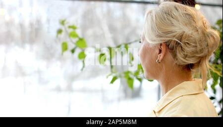 Side view of anonymous female with blond hair wearing dress and smelling  blossoming lavender flowers while enjoying nature in sunset Stock Photo -  Alamy