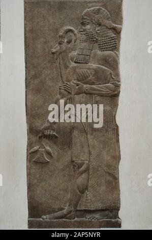 Man holding an Ibex and a poppy flower. Relief from the Palace of Sargon II in Dur Sharrukin, 713-706 BC (Khorsabad, Iraq). Louvre Museum. Paris, France. Stock Photo