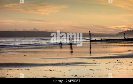 Bournemouth Beach at Dusk with a couple taking pictures Stock Photo