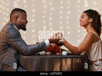 African couple in love having valentine dinner at restaurant Stock Photo