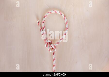 Bowline ship knot on wooden background Stock Photo