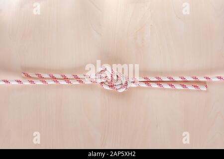 Figure eight Bend or Flemish Bend ship knot on wooden background Stock Photo