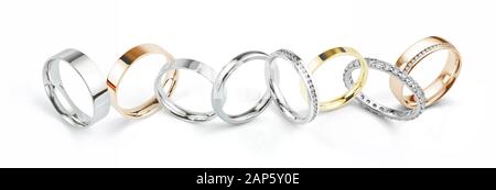 Assorted Wedding Rings in White Gold, Yellow Gold and Rose Gold. Wide Landscape Banner Style Photograph Isolated on White Background. Stock Photo