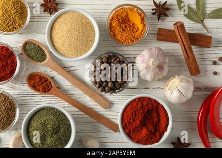 Bowls with spices and ingredients on wooden background, top view Stock Photo