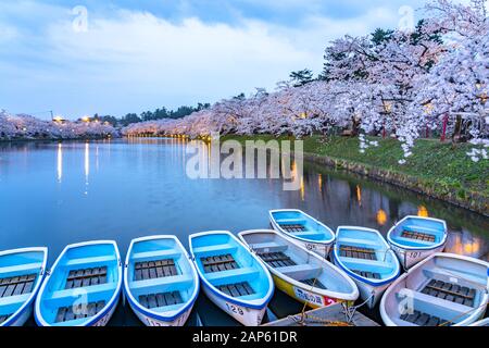 Hirosaki park cherry blossoms matsuri festival in springtime season. Beauty full bloom pink sakura flowers light up at night in west moat. Aomori Stock Photo