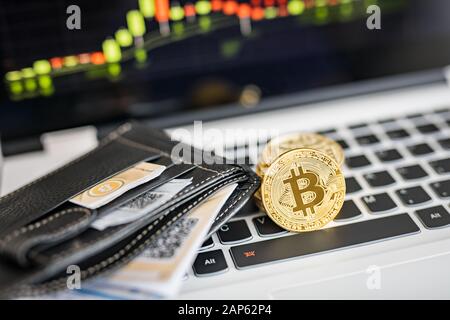 Virtual currency wallet. Bitcoin gold coin and printed encrypted money with QR code. Cryptocurrency concept. Stock Photo