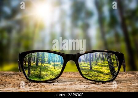 glasses focus background wooden eye vision lens eyeglasses nature reflection look looking through see clear sight concept transparent sunrise prescrip Stock Photo