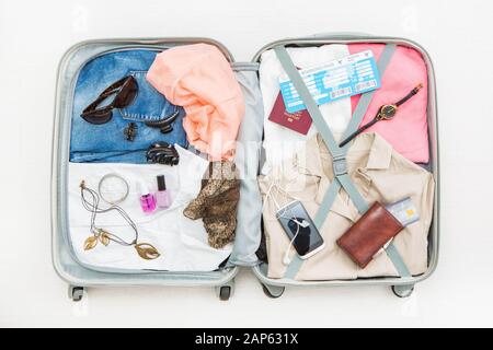 travel traveler traveling bag top open view packing card camera packed credit wallet clothing table leaving departure concept - stock image Stock Photo
