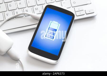 Phone charging with energy bank. Stock Photo