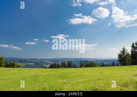 Summer mountains green grass and blue sky landscape Stock Photo