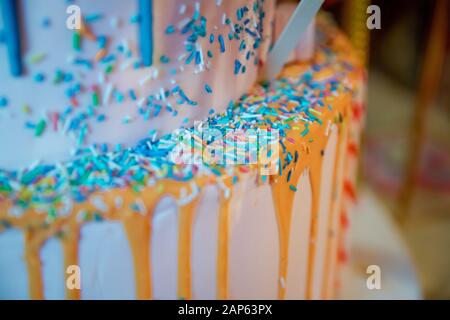 Close up photo of homemade russian easter cakes decorated with white glaze and small colored sugar balls . blue cake with colorfull small sweet ball Stock Photo