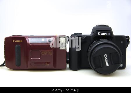 2020.Spain. Two Canon cameras, the one on the left is the compact reel model: AF35J. The one on the right a canon m50 mirrorles of interchangeable obj Stock Photo