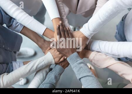 International business team putting hands together in cooperation Stock Photo