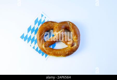 Concept of bavarian food. Traditional baked bavarian salted pretzels on white background. Stock Photo