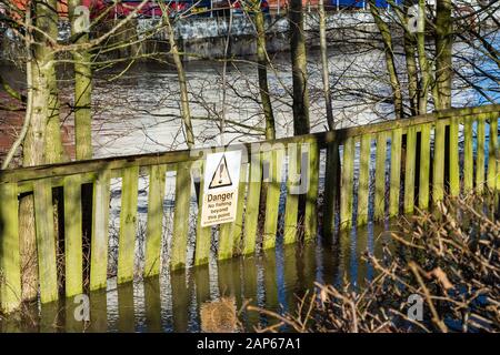 A 'No fishing' sign on a fence partially submerged and surrouned by flooding along the riverside walk in Melksham Wiltshire Stock Photo