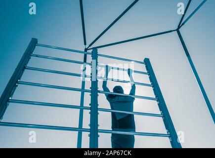 Man using outdoor beach gym in Spain Stock Photo