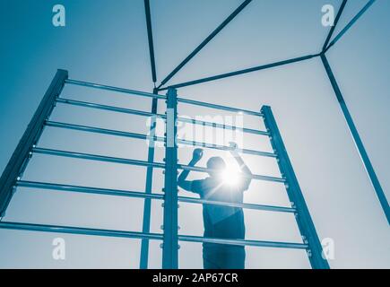 Man using outdoor beach gym in Spain Stock Photo