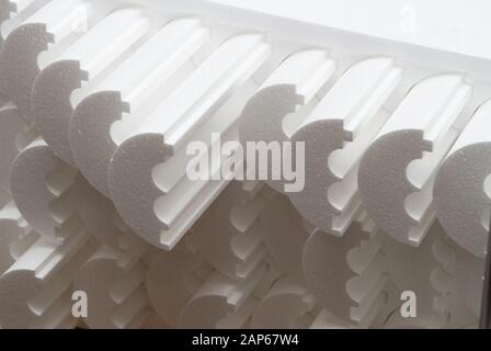 Small private production for cutting out products and figures made of foam on a machine with electric heating. Production of insulation for pipes Stock Photo