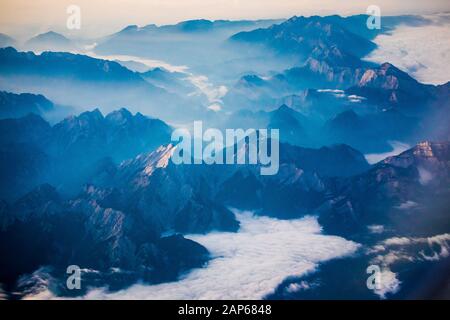 Misty Alpen valleys, aerial view of central Austria in the morning Stock Photo