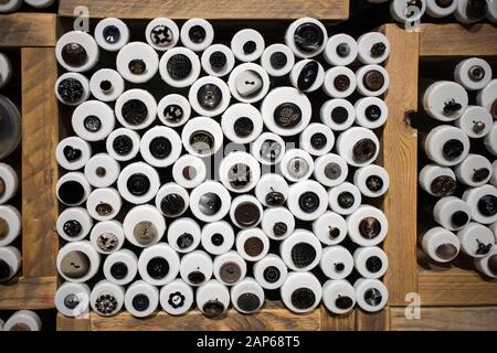Multi-colored buttons in wooden boxes for sale in a store. Stock Photo