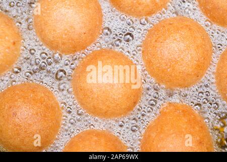 fritters in the process of cooking, traditional Colombian food. Stock Photo